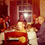 Thanksgiving in 1960, dining room table and chairs, middle chair, me, and camera, my father. 