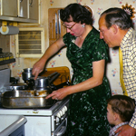 Thanksgiving in 1960 in kitchen Dorothy top of the stove stove cooking stuffing, Ded and Garret!